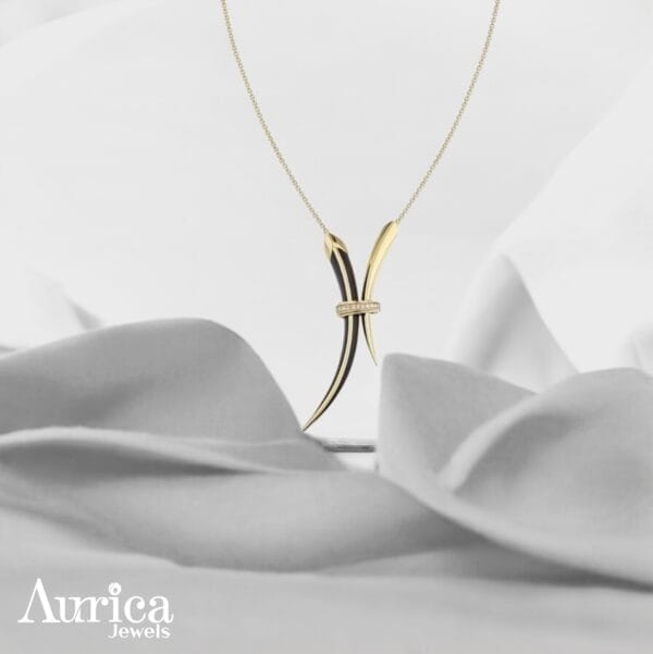 The Golden Horn Pendant is a striking metallic piece that embodies strength, elegance, and individuality.