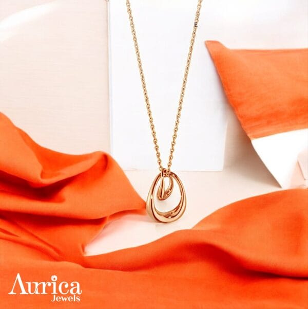 This stunning Golden Loop Pendant embodies effortless elegance, its sleek metallic design combines modern aesthetics with a timeless appeal.