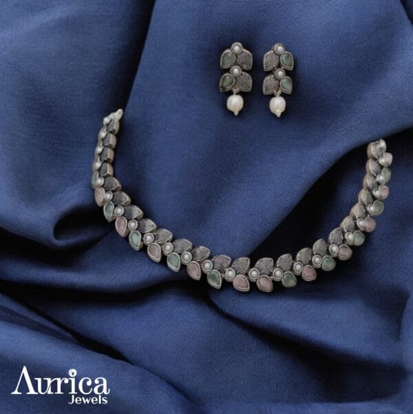 Inspired by the gentle elegance of blooming flowers, the Petal Whisper Oxidised Necklace evokes the softness of nature’s quiet beauty.